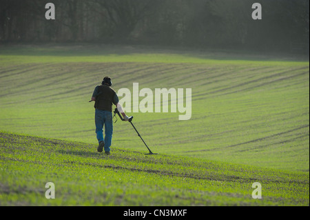 A Man Searches For Buried Treasure Using A Metal Detector On Eastbourne