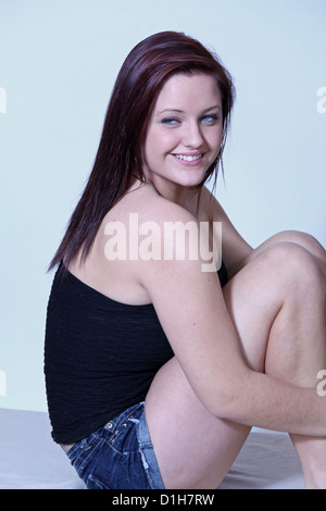 http://l450v.alamy.com/450v/d1h7rw/very-pretty-blue-eyed-young-lady-brunette-in-a-strapless-black-top-d1h7rw.jpg