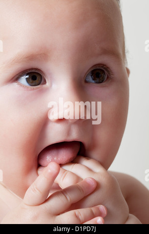 Baby With Hands In Mouth Stock Photo Alamy