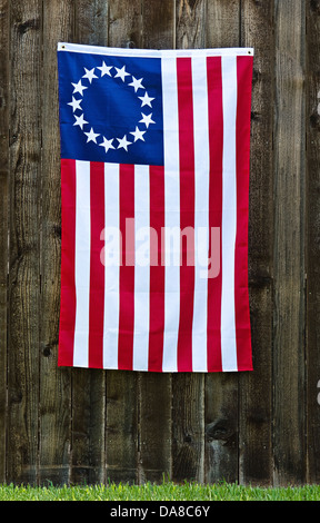 An American Flag With A Circle Of 13 Stars On A Historic Street In 