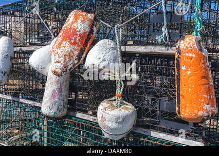 Colorful lobster trap buoys on display at a dock on Cape 