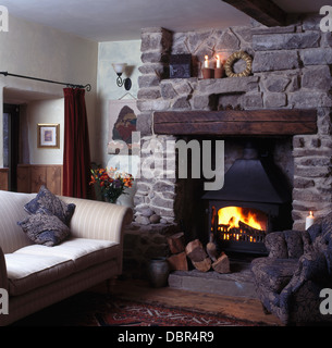 Cottage Living Room With Fireplace lighted candles fireplace with wood-burning stove in cottage Cottage Living Room With Fireplace lighted candles fireplace with wood-burning stove in cottage