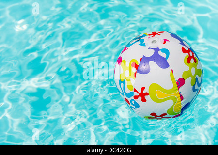 Pool Water With Beach Ball colorful beach ball floating on water of swimming pool stock photo Pool Water With Beach Ball colorful beach ball floating on water of swimming pool stock photo