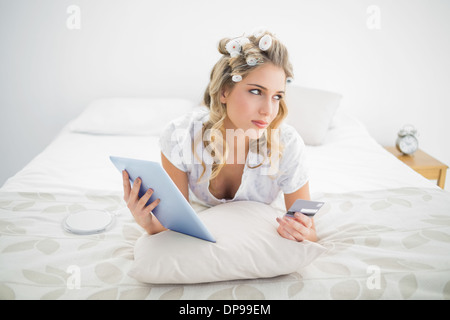 Pensive Cute Blonde Wearing Hair Curlers Using Laptop Stock Photo Alamy