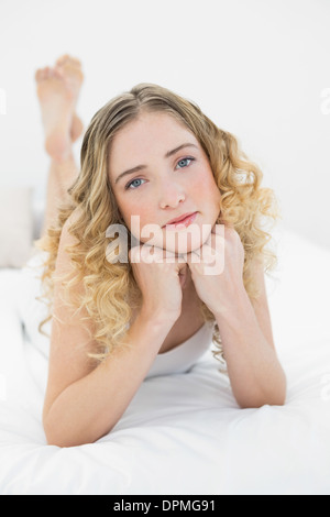 Pretty Thoughtful Blonde Lying On Bed Using Smartphone Stock Photo Alamy