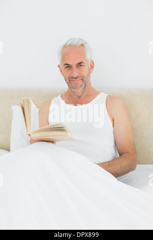 Mature Man Reading Book In Leather Armchair Stock Photo Alamy