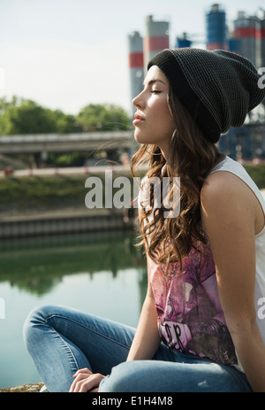 young woman wearing knit hat with eyes closed e1h4m8