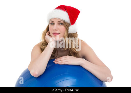 Festive Fit Blonde Leaning On Exercise Ball Against Yellow Abstract