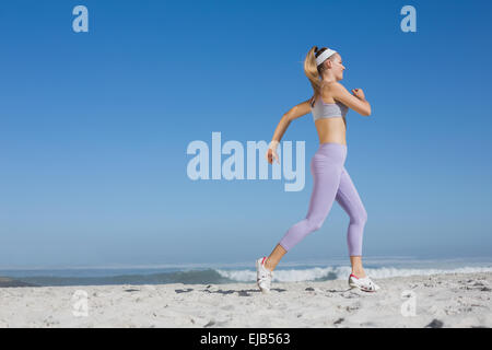 Sporty Smiling Blonde Jogging On The Beach Stock Photo Alamy