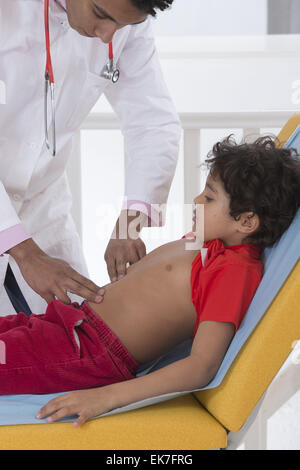 Doctor palpating the abdomen of a 5-month-old baby boy 
