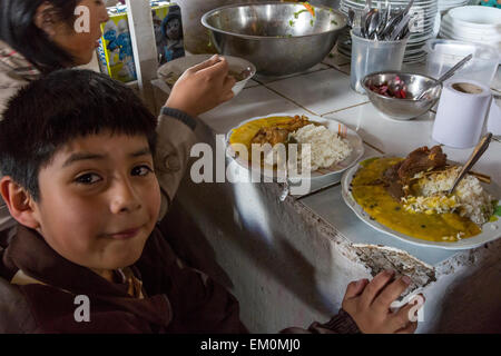 Peru, Cusco, <b>San Pedro</b> Market. Young Boy with his Lunch of Rice, - peru-cusco-san-pedro-market-young-boy-with-his-lunch-of-rice-beef-em0mj0