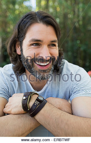 Close Up Portrait Of A Handsome Bearded Man With Earphones In A Hat