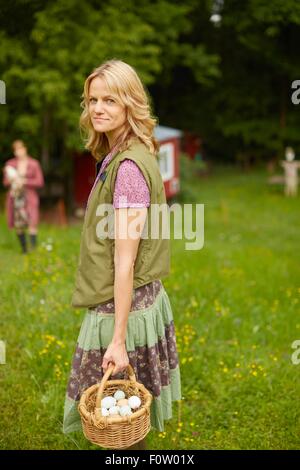 Portrait Of Mature Woman Holding Basket With Baguettes Stock Photo Alamy