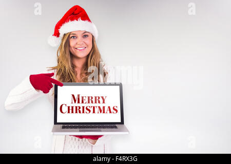 Composite Image Of Festive Blonde Pointing To Laptop Stock Photo Alamy