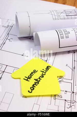 house of yellow paper with text home construction and rolls of diagrams lying on electrical construction - Home Construction Diagram house of yellow paper with text home construction and rolls of diagrams lying on electrical construction - Home Construction Diagram