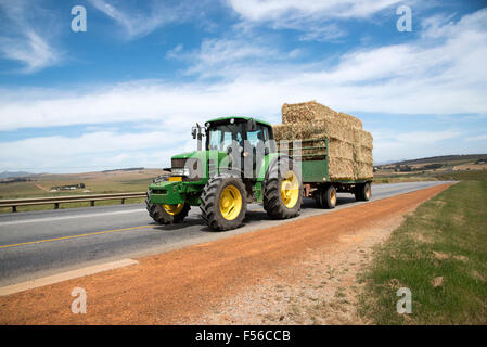 A Tractor Pulling A Trailer Of Hay Bales In Gloucestershire UK Stock