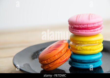 Colorful Macaroon In Black Dish On Wooden Floor Stock Photo Alamy