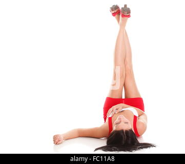 Cute Woman Legs Raised Up High And Arms Under Her Head Lying On Bed