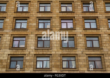 Apartment Building Front many windows in row on facade of urban apartment building front Apartment Building Front many windows in row on facade of urban apartment building front
