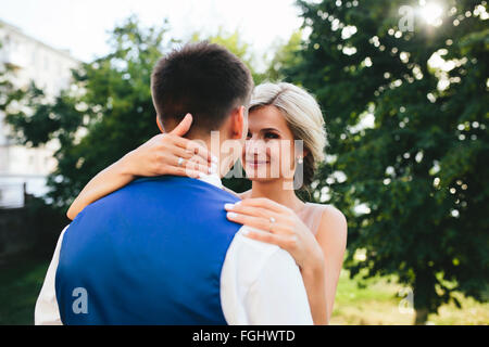 http://l450v.alamy.com/450v/fghwtd/beautiful-wedding-couple-hugging-in-the-park-fghwtd.jpg