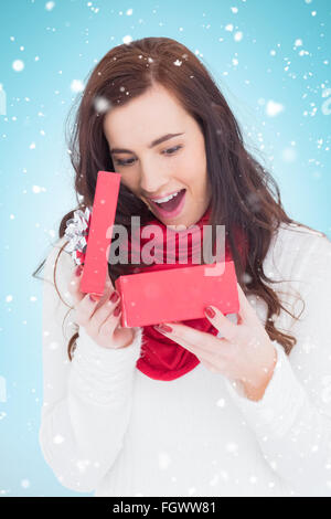 Composite Image Of Surprised Brunette Opening Gift Bag At Chistmas