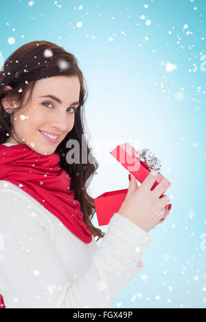 Composite Image Of Festive Brunette Opening Gift Bag Stock Photo Alamy