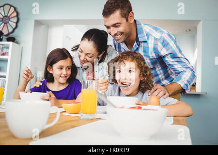 http://l450v.alamy.com/450v/fk0rt9/cheerful-man-and-woman-with-children-during-breakfast-fk0rt9.jpg