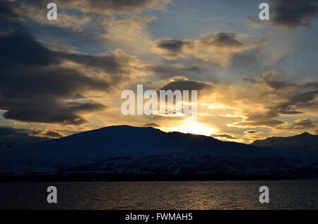 Golden Vibrant Sunset Over Snowy Mountain And Fjord Landscape Stock