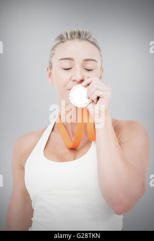 Female Athlete Kissing Gold Medal Stock Photo Alamy