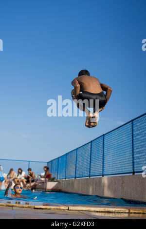 Pool Splash Cannonball boy does a cannonball into the pool stock photo, royalty free Pool Splash Cannonball boy does a cannonball into the pool stock photo, royalty free