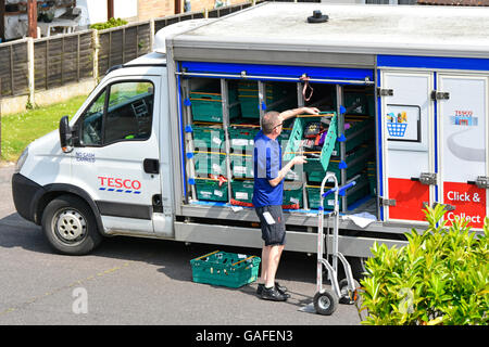 tesco delivery van supermarket driver unloading groceries street trolley onto alamy address residential road shopping internet man