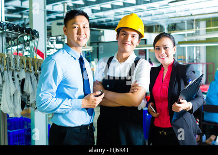 showing the list workersproduction manager and owner in factory stock photo - Fashion Production Manager showing the list workersproduction manager and owner in factory stock photo - Fashion Production Manager