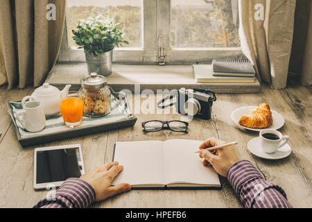 hipster having coffee and writing in planner stock photo, royalty hipster having coffee and writing in planner stock photo, royalty