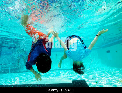 kids swimming underwater in pool enjoying the relaxation of summer stock photo - Kids Swimming Underwater kids swimming underwater in pool enjoying the relaxation of summer stock photo - Kids Swimming Underwater
