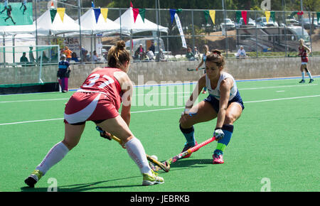 Two Topless Female Hockey Players In Front Of A Goalie Net Stock Photo