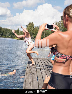 Girls In Bikini Jumping Into Lake Seattle Washington Usa Stock Photo