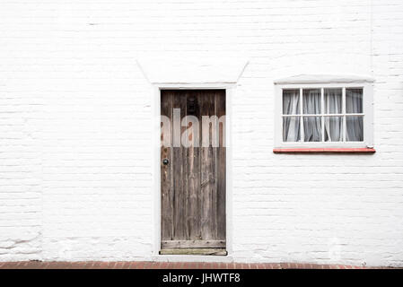 White Front Door Texture wooden front door and window on a typical cotswold stone house in White Front Door Texture wooden front door and window on a typical cotswold stone house in
