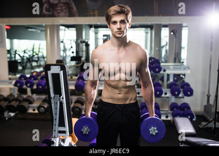 Very Brawny Guy Bodybuilder Execute Exercise With Weight Stock Photo