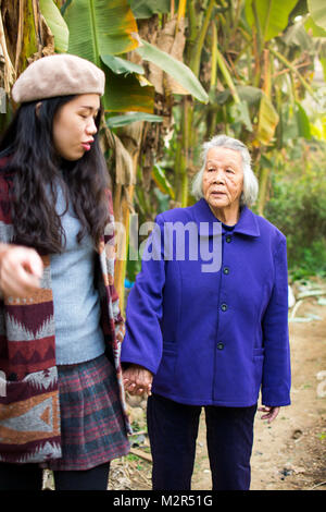 http://l450v.alamy.com/450v/m2r51g/asian-girl-having-a-walk-with-her-grandma-in-green-tropical-environment-m2r51g.jpg