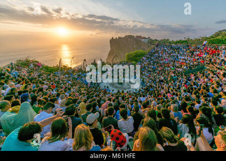 Tourists Watching Sunset With A Traditional Balinese Kecak Dance At