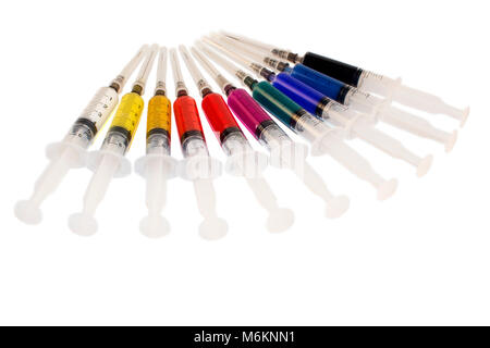 Disposable Syringes With Needle And Multicolored Medicine On White