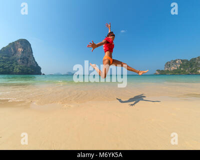 Carefree Woman In Bikini Jumping On The Beach Stock Photo Alamy