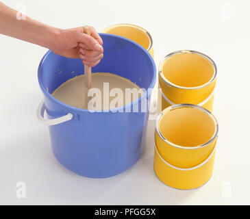 Three Tins Of Paint In A Bucket Stock Photo Alamy