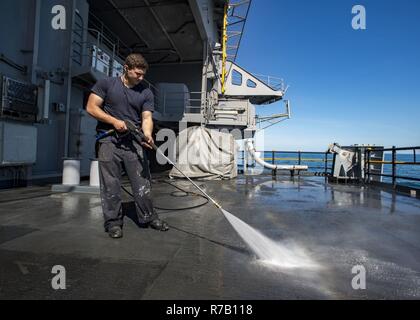 Us Navy A Sailor Washes The Fantail Of Uss Cape St George Stock