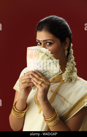 South Indian Woman Showing Five Hundred Rupees Banknote And Smiling