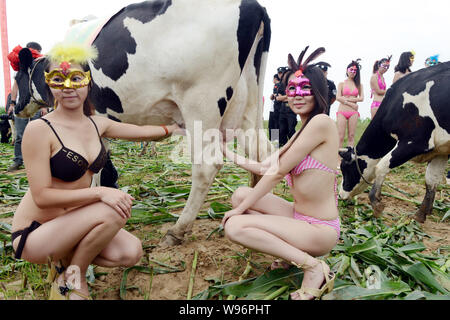 Chinese Bikini Dressed Models Pose In Line In The Water At Sanya