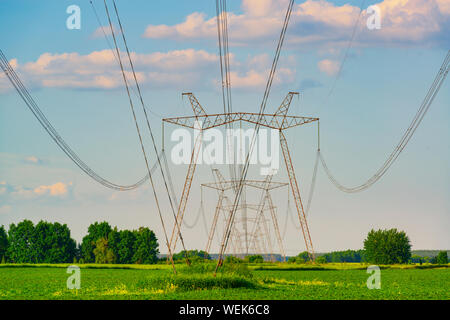 Supports High Voltage Powerline Pylon Against Silhouette In Epic Sunset