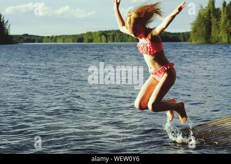 Girls In Bikini Jumping Into Lake Seattle Washington USA Stock Photo