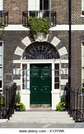 Decorative stonework surrounding a grand front entrance to a ... Decorative stonework surrounding a grand front entrance to a ...