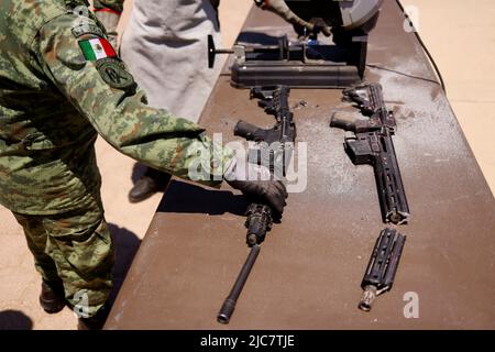 Un miembro del ejército mexicano destruye un arma durante una